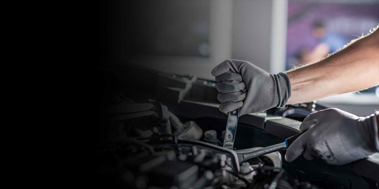 Mechanic working on the front portion of the car